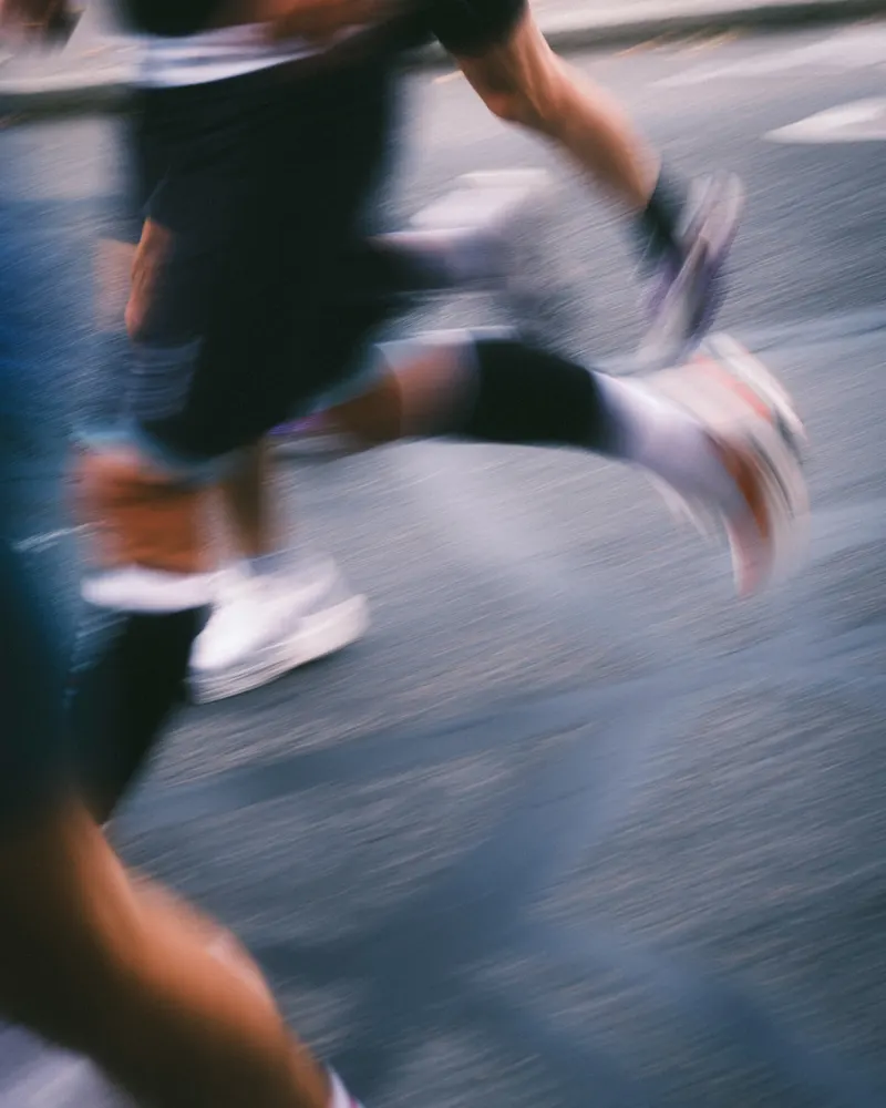 Runners mid-stride on a road
